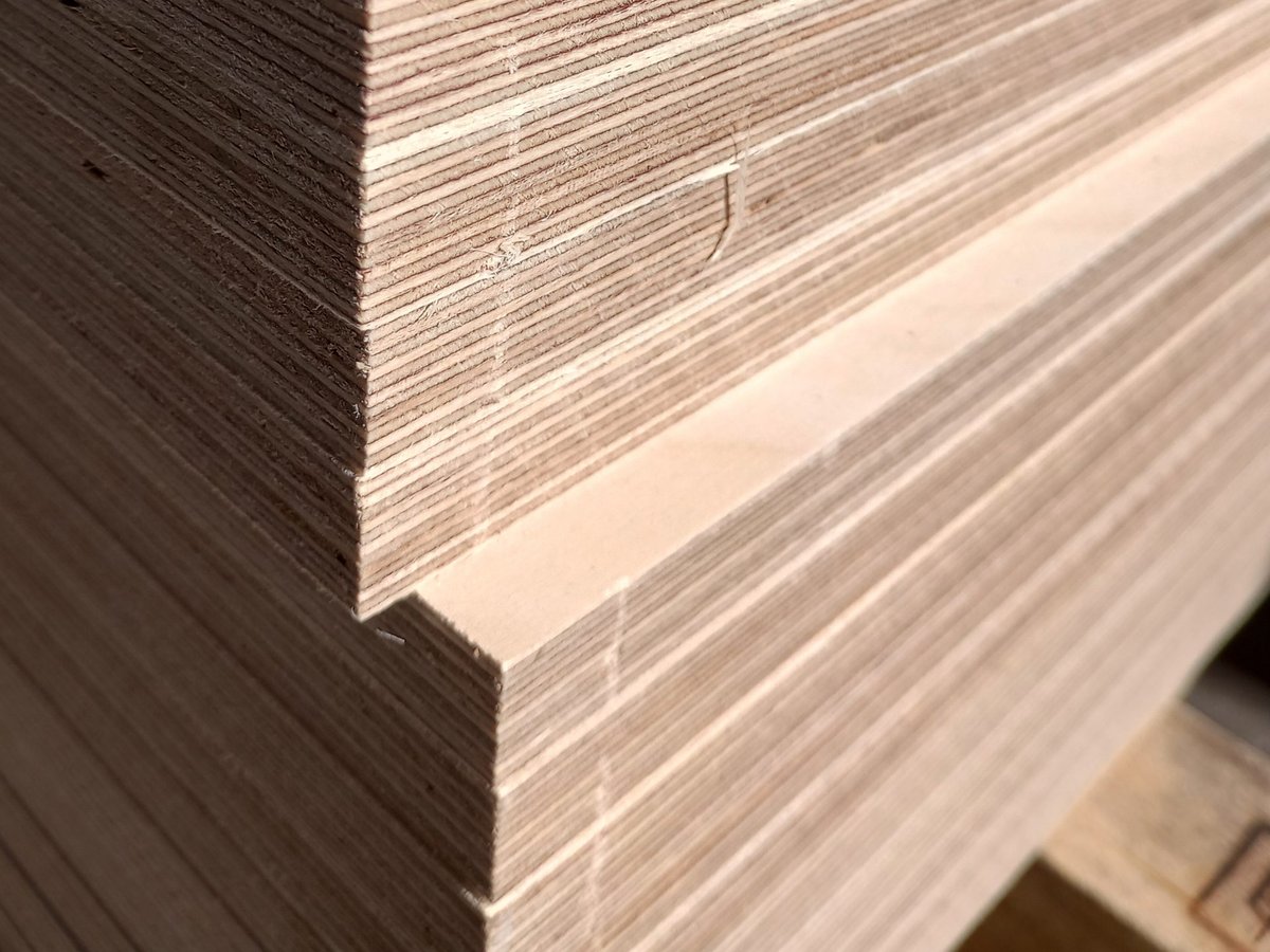 Close-up of the stepped corner of a stack of Baltic birch plywood sheets, showing the many thin plies along each edge